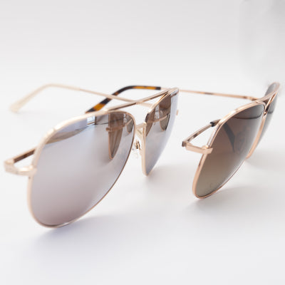 two women's aviator sunglasses in rose gold - front view.